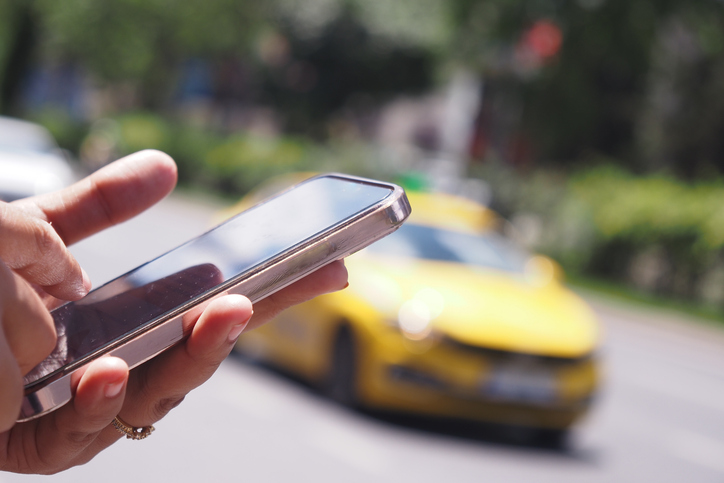 Passenger using a ride-share app on a phone
